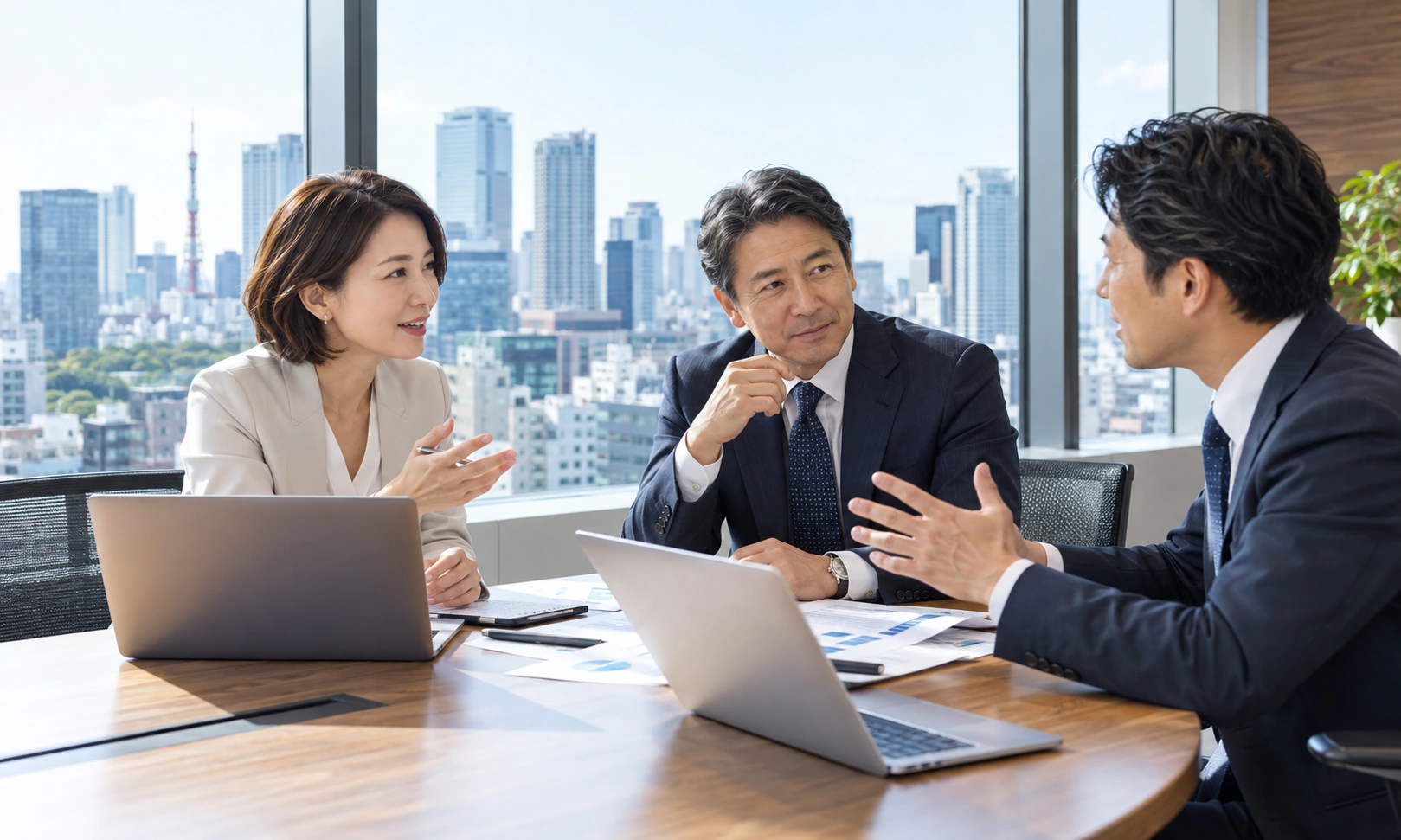 眺望のよいオフィスで議論するビジネスチーム（イメージ）